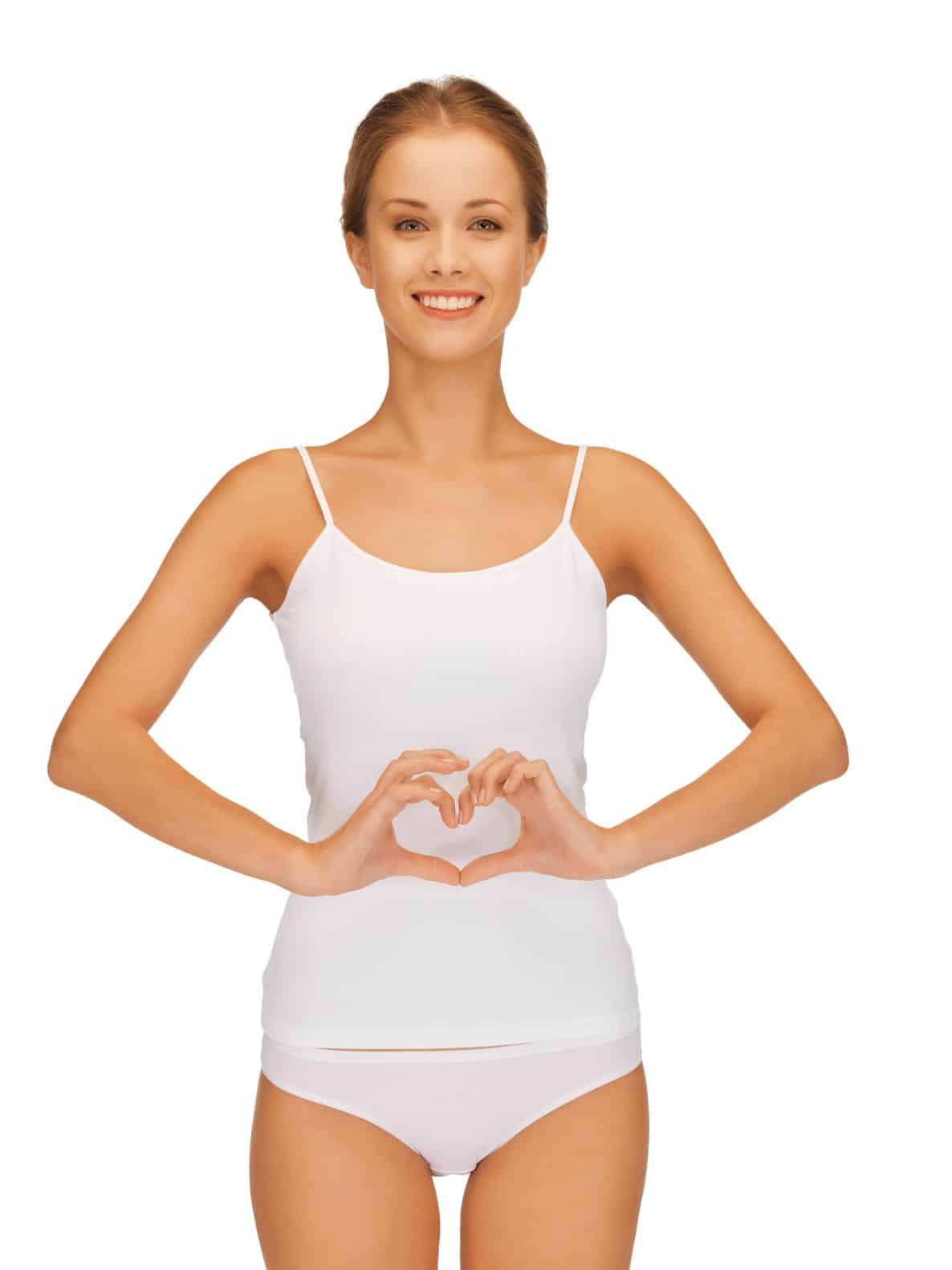 15691684 - picture of beautiful woman in cotton undrewear forming heart shape on belly